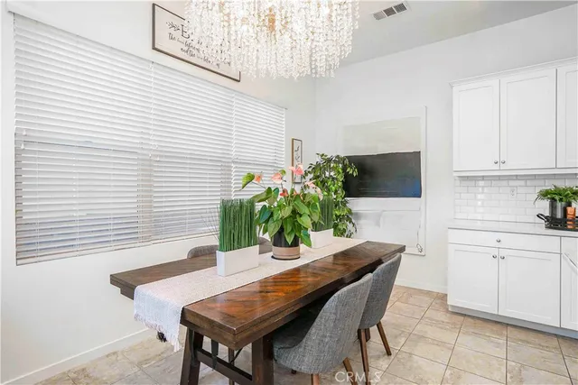 a dining room with furniture and potted plant