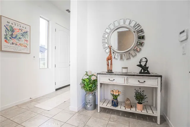 a living room with furniture and a mirror
