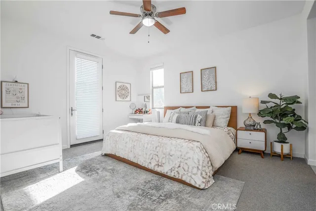 a spacious bedroom with a bed and a couch