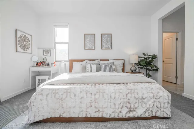 a bedroom with a bed and a table