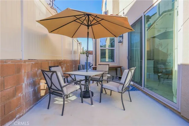 a patio with a patio table and chairs