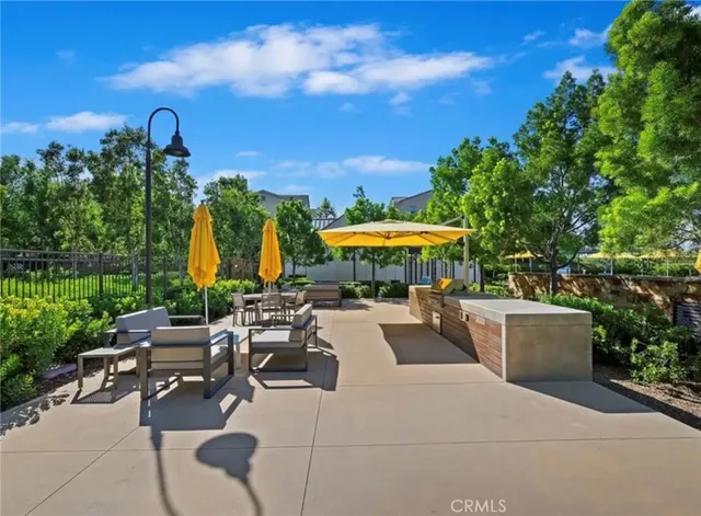 a view of a terrace with furniture and a garden