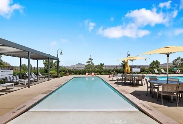 a view of a swimming pool with outdoor seating and plants