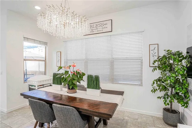 a dining room with furniture and potted plant