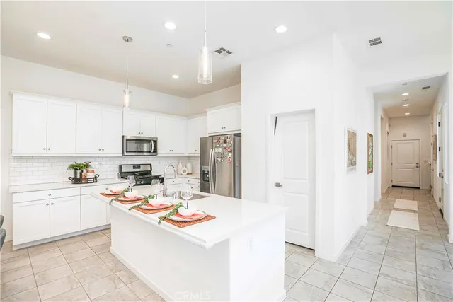 a kitchen with stainless steel appliances a refrigerator sink and cabinets