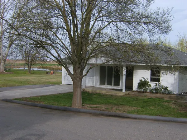 a view of a small house in the middle of a yard