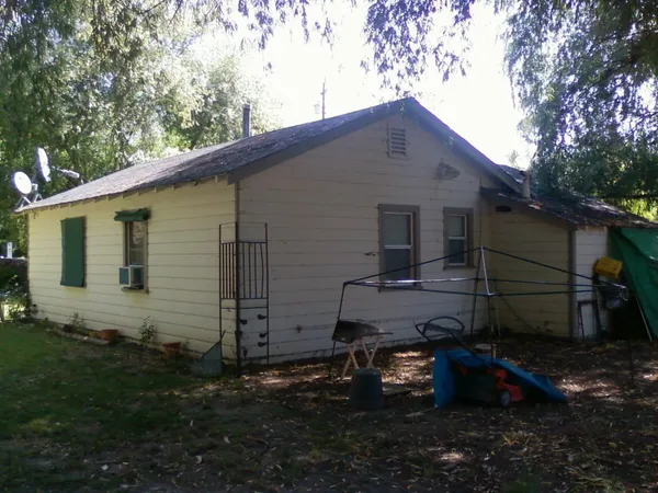 a backyard of a house with wooden fence