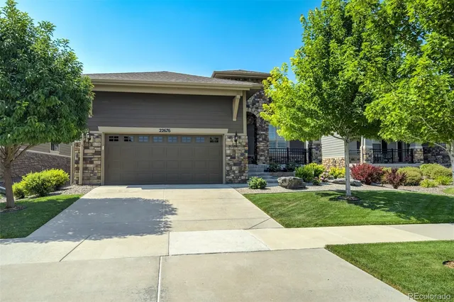 a front view of a house with a yard and a garage