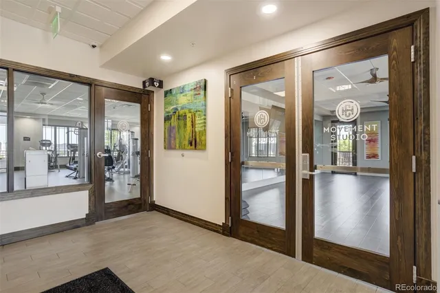 a view of a living room and kitchen with furniture wooden floor and windows