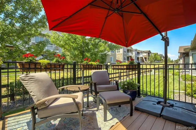 a view of a balcony with a yard