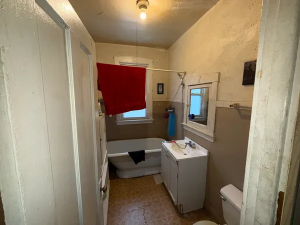 a kitchen with granite countertop a refrigerator and a sink