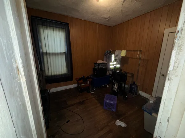 a view of a closet with clothes and shoes