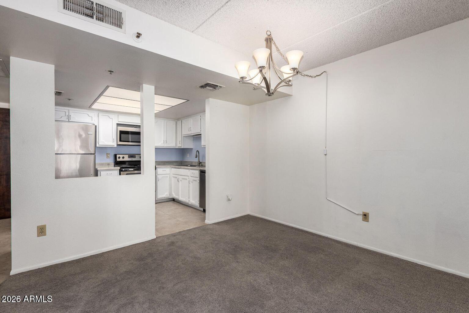7950 East Camelback Road, Unit 28205 Scottsdale, AZ 85251 - Photo 11 of 23 a view of a kitchen with a sink and a refrigerator
