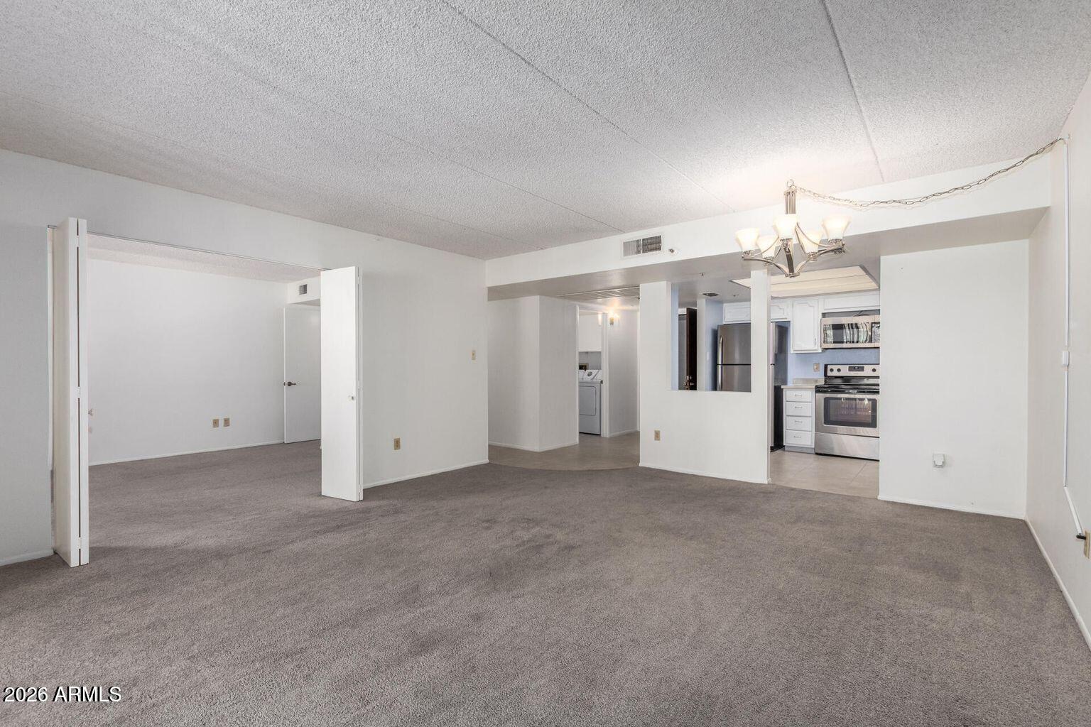 7950 East Camelback Road, Unit 28205 Scottsdale, AZ 85251 - Photo 12 of 23 an empty room with a empty space and windows