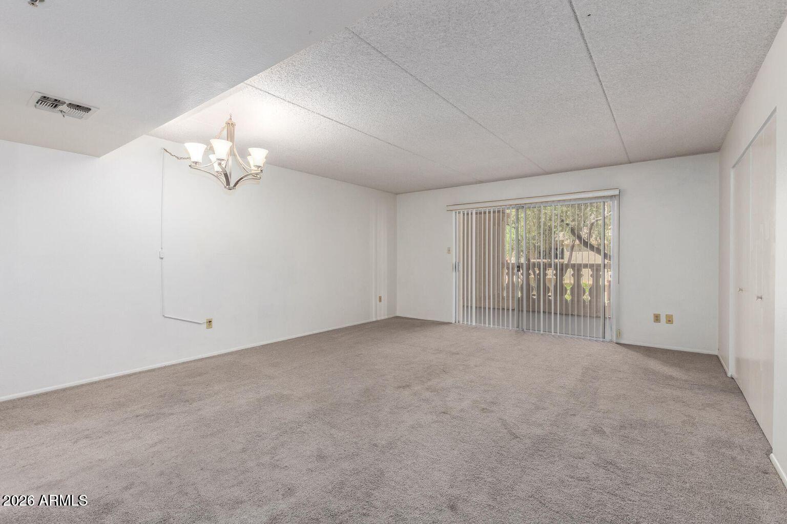 7950 East Camelback Road, Unit 28205 Scottsdale, AZ 85251 - Photo 13 of 23 wooden floor in an empty room with a window