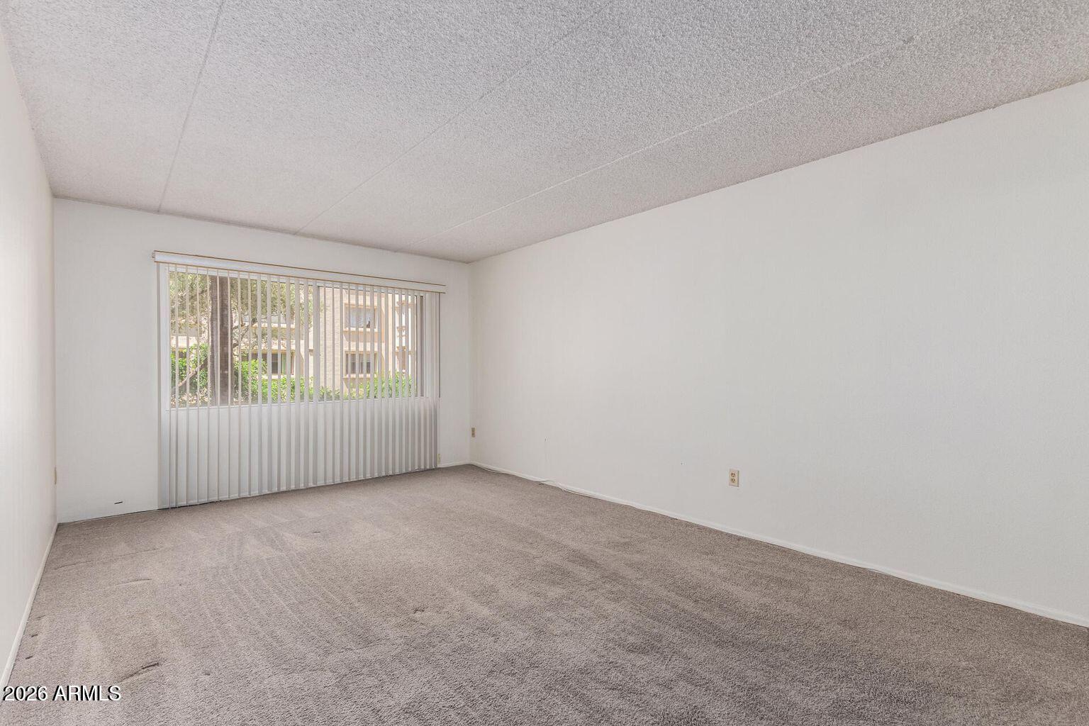 7950 East Camelback Road, Unit 28205 Scottsdale, AZ 85251 - Photo 15 of 23 a view of an empty room with a window