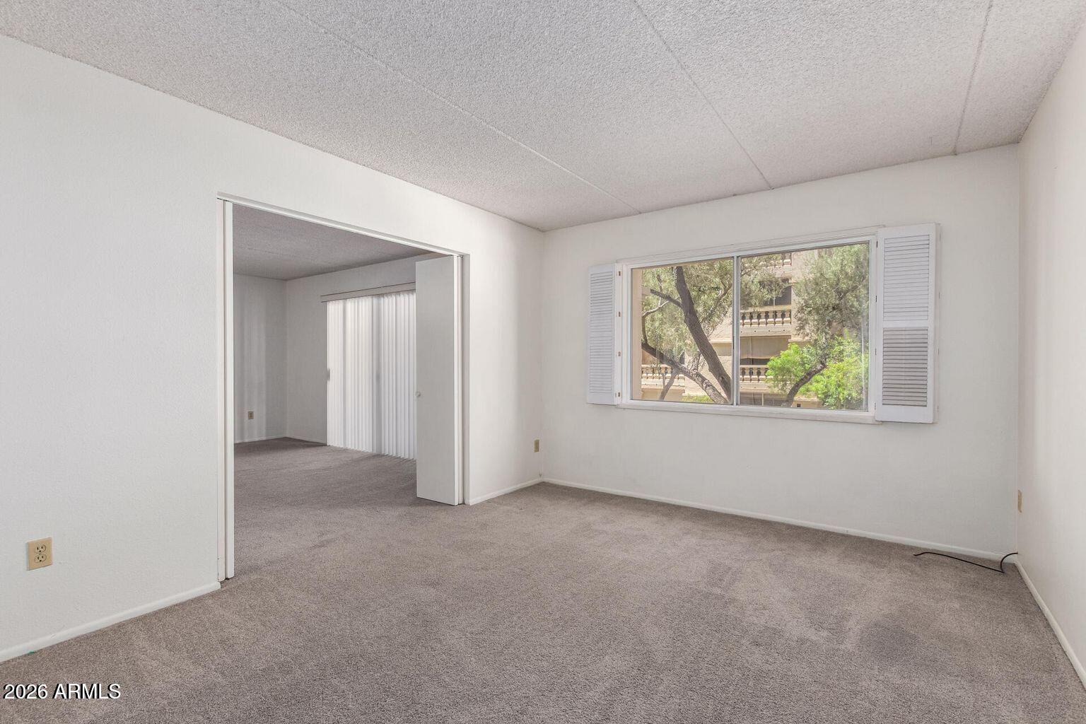 7950 East Camelback Road, Unit 28205 Scottsdale, AZ 85251 - Photo 20 of 23 an empty room with windows and closet