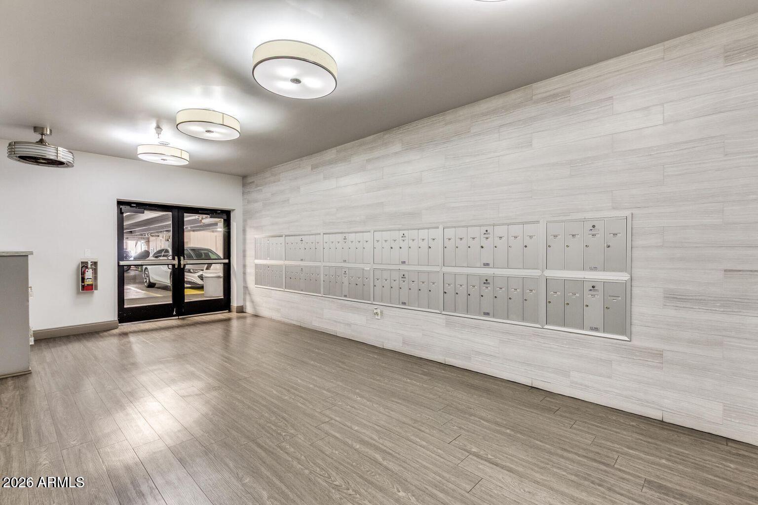 7950 East Camelback Road, Unit 28205 Scottsdale, AZ 85251 - Photo 2 of 23 a view of an empty room with wooden floor and a window