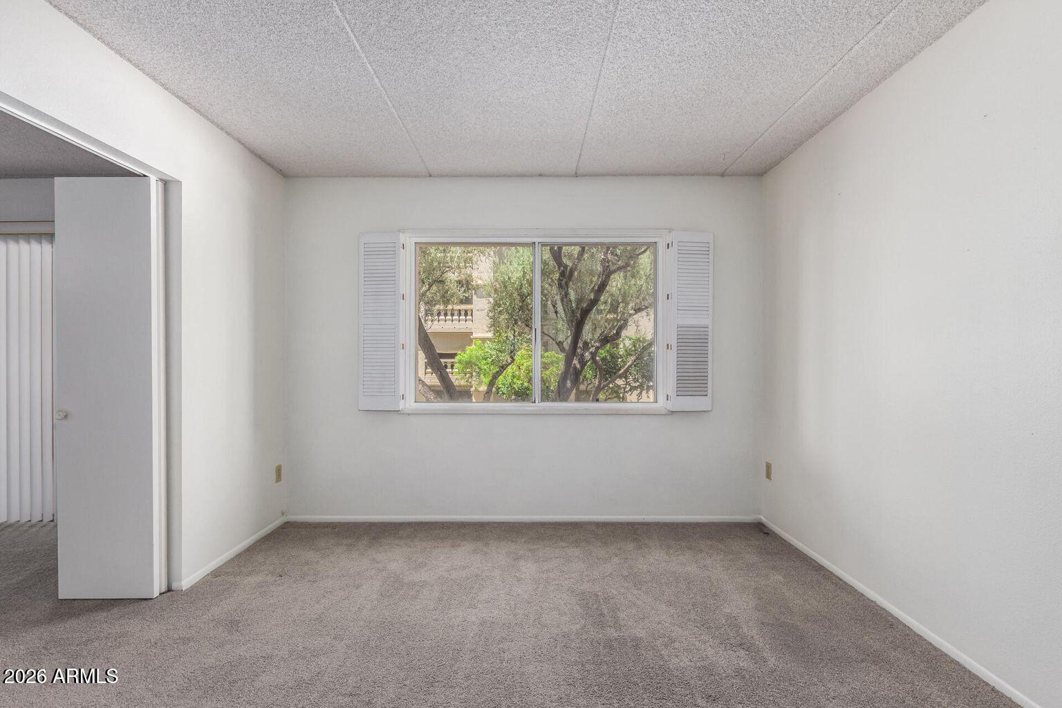 7950 East Camelback Road, Unit 28205 Scottsdale, AZ 85251 - Photo 22 of 23 an empty room with a window