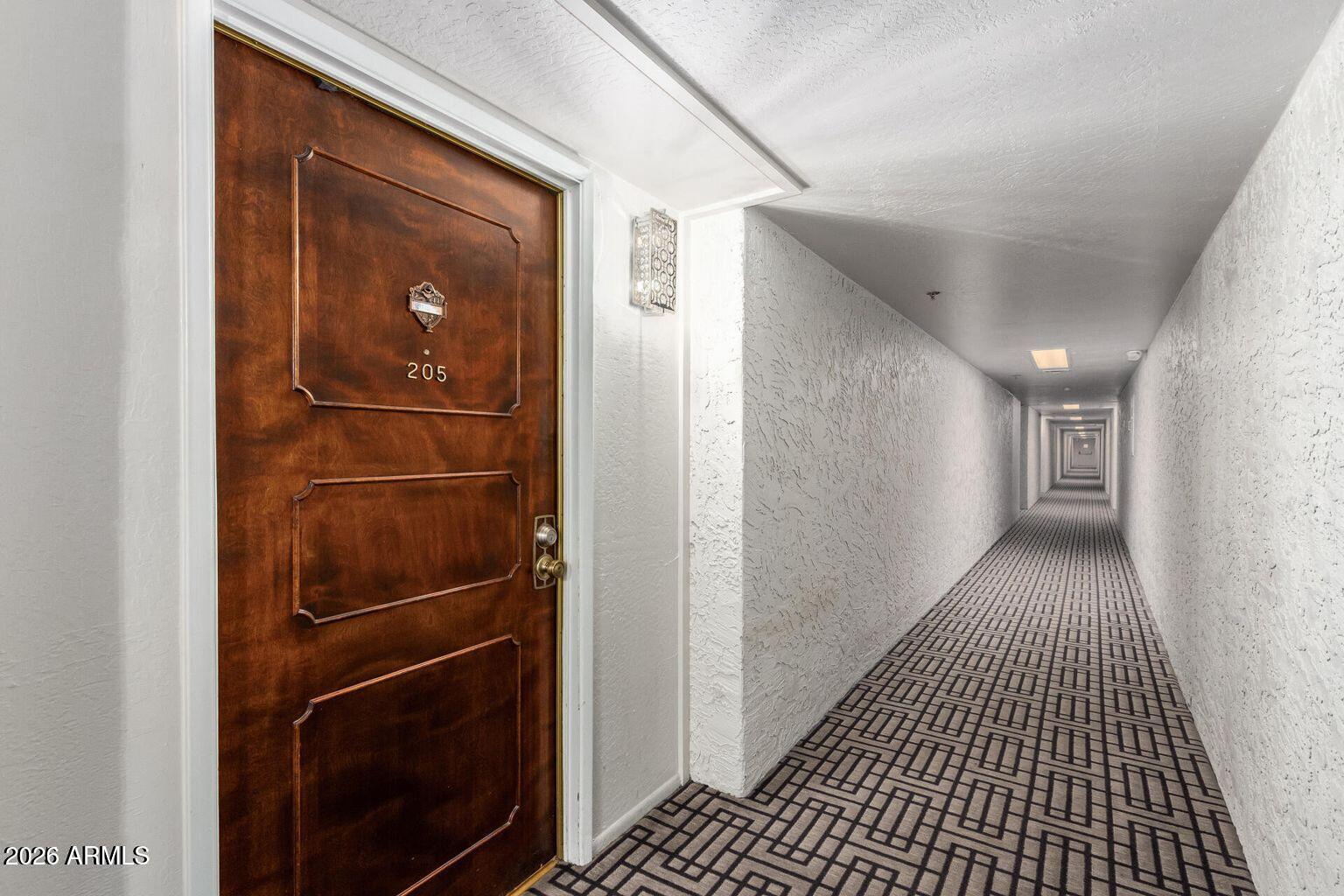 7950 East Camelback Road, Unit 28205 Scottsdale, AZ 85251 - Photo 5 of 23 a view of hallway with wooden floor