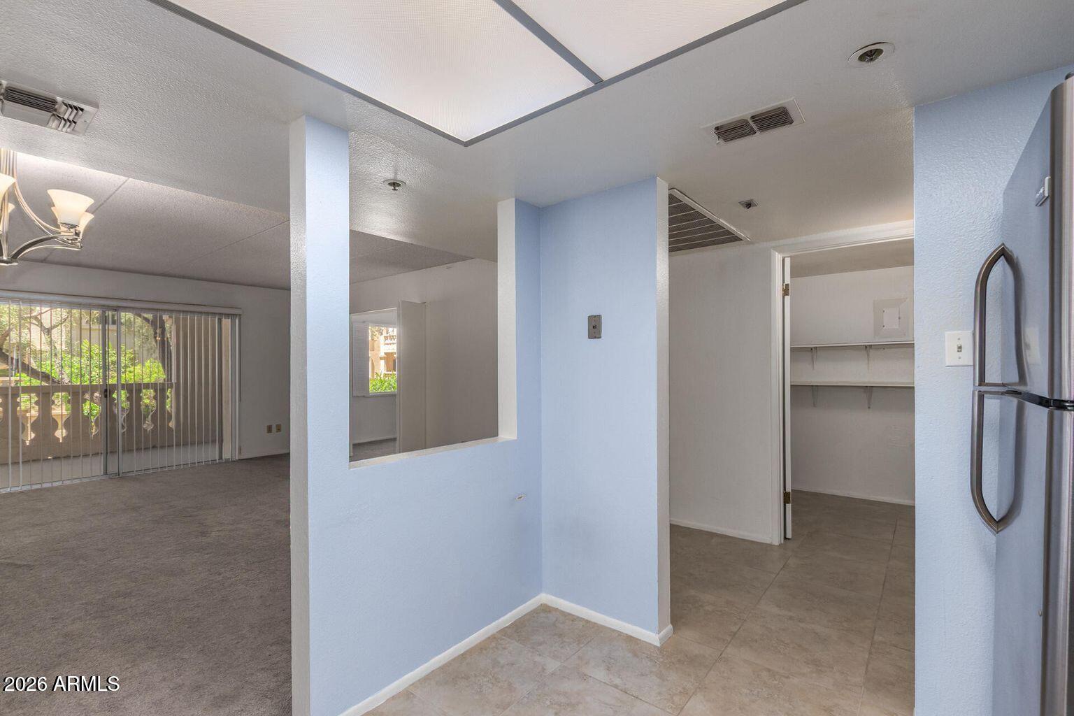 7950 East Camelback Road, Unit 28205 Scottsdale, AZ 85251 - Photo 9 of 23 a view of a hallway with wooden shelves