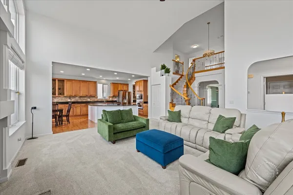 a living room with furniture and a view of kitchen