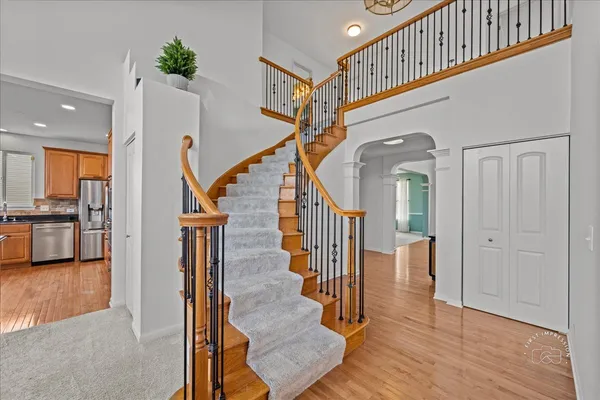a view of entryway and hall with wooden floor
