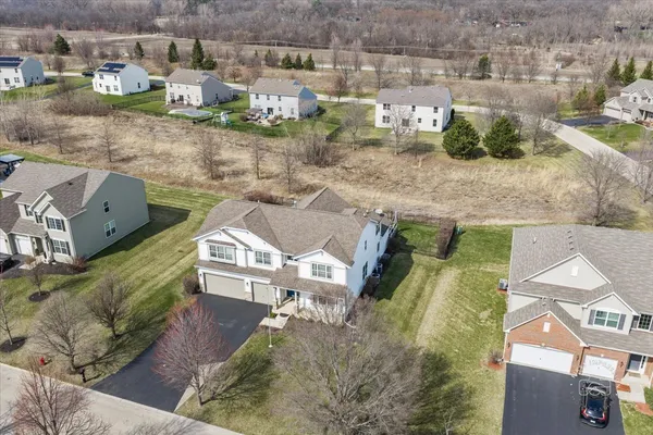 an aerial view of a house with a yard
