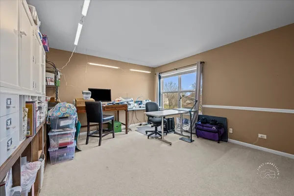 a view of a livingroom with workspace and a window