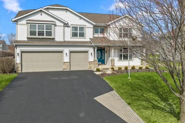 a front view of a house with a yard and garage