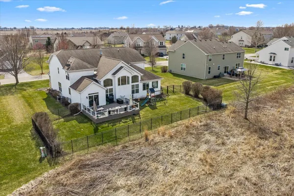 an aerial view of a house with a big yard