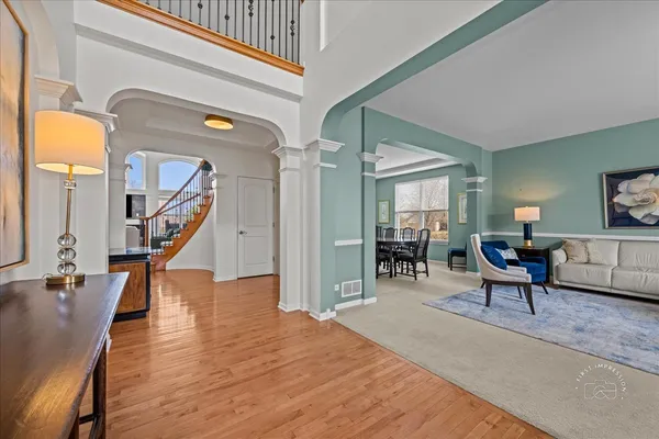 a living room with furniture and a wooden floor