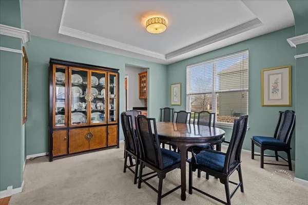 a view of a dining room with furniture and window