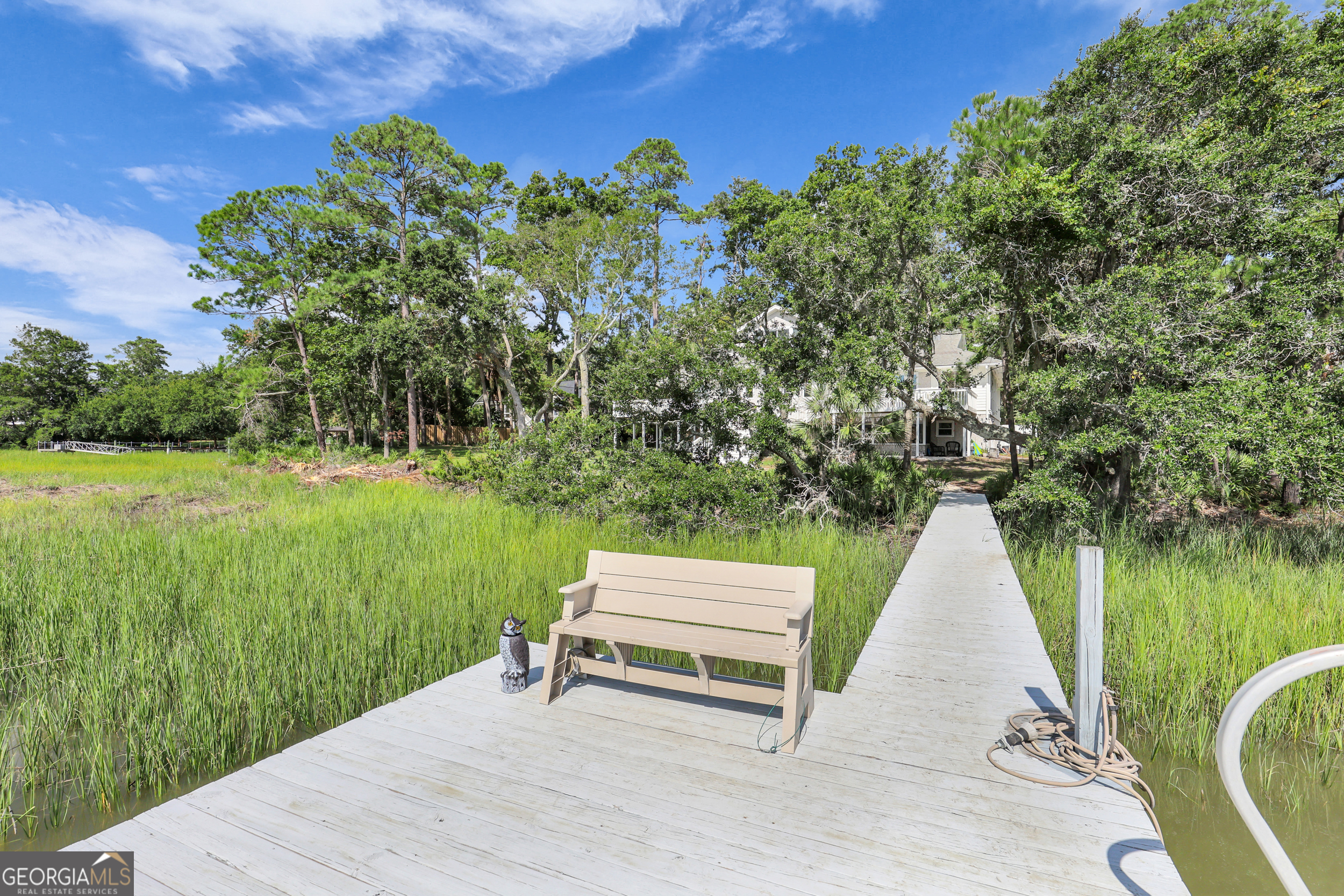 18 Modena Island Drive Savannah, GA 31411 - Photo 45 of 48 a wooden bench sitting in the middle of a lake