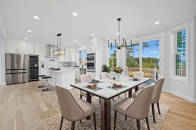 a dining room with furniture a chandelier and wooden floor