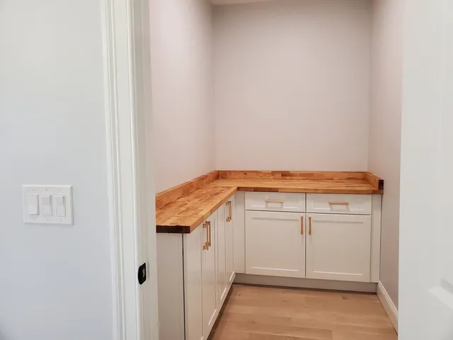 a view of a kitchen with white cabinets
