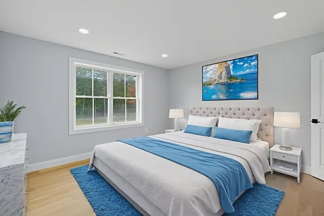 a bedroom with bed and a window