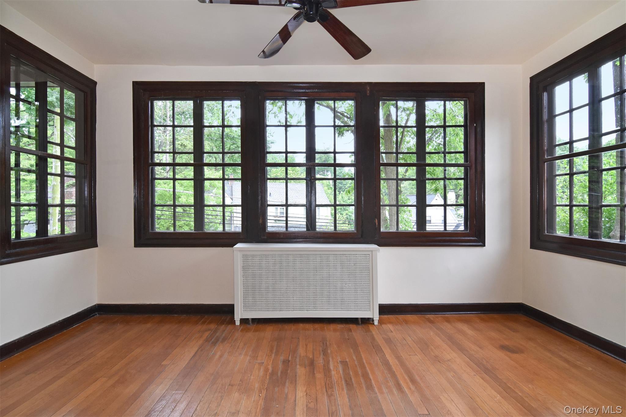 370 Scarsdale Road Tuckahoe, NY 10707 - Photo 9 of 25 Inviting sun room with hardwood floors and large windows