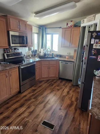 a kitchen with a sink stove and wooden cabinets
