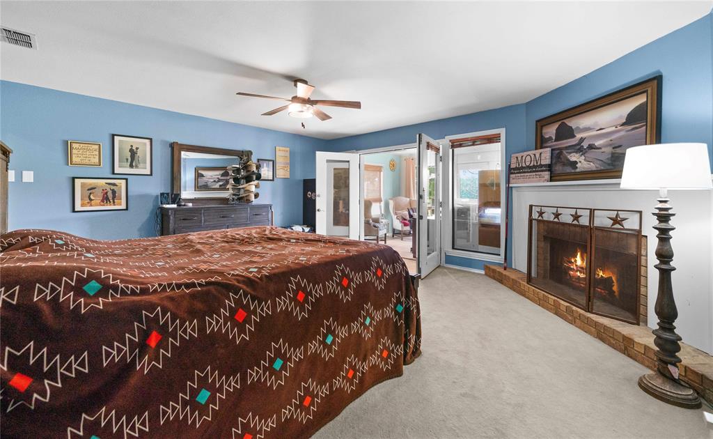 126 County Road, Unit 4212 Jacksonville, TX 75766 - Photo 13 of 39 a spacious bedroom with a bed and a fireplace