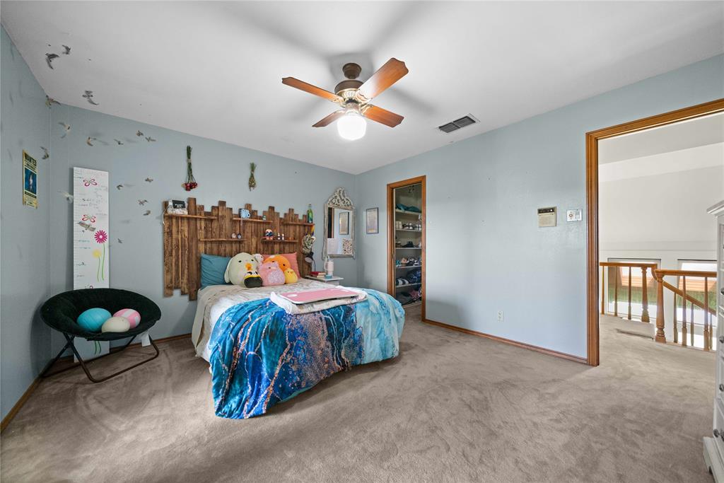 126 County Road, Unit 4212 Jacksonville, TX 75766 - Photo 21 of 39 a bed room with a bed and a chandelier