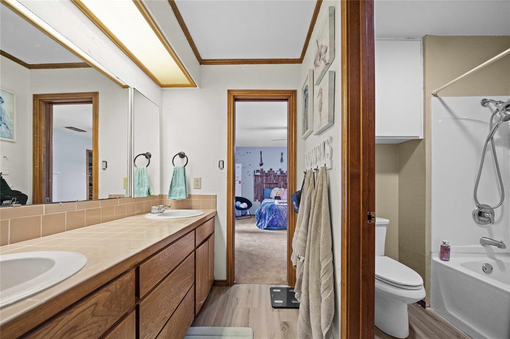 126 County Road, Unit 4212 Jacksonville, TX 75766 - Photo 27 of 39 a spacious bathroom with a granite countertop sink toilet and shower