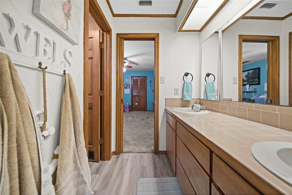 126 County Road, Unit 4212 Jacksonville, TX 75766 - Photo 28 of 39 a bathroom with a sink a mirror and a shower