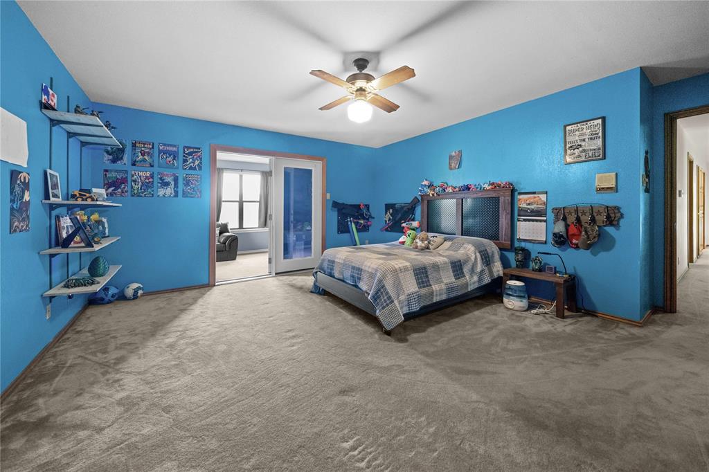 126 County Road, Unit 4212 Jacksonville, TX 75766 - Photo 29 of 39 a bedroom with a bed and a chandelier