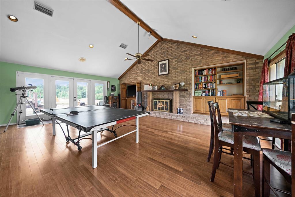 126 County Road, Unit 4212 Jacksonville, TX 75766 - Photo 7 of 39 a living room with furniture a wooden floor and a piano