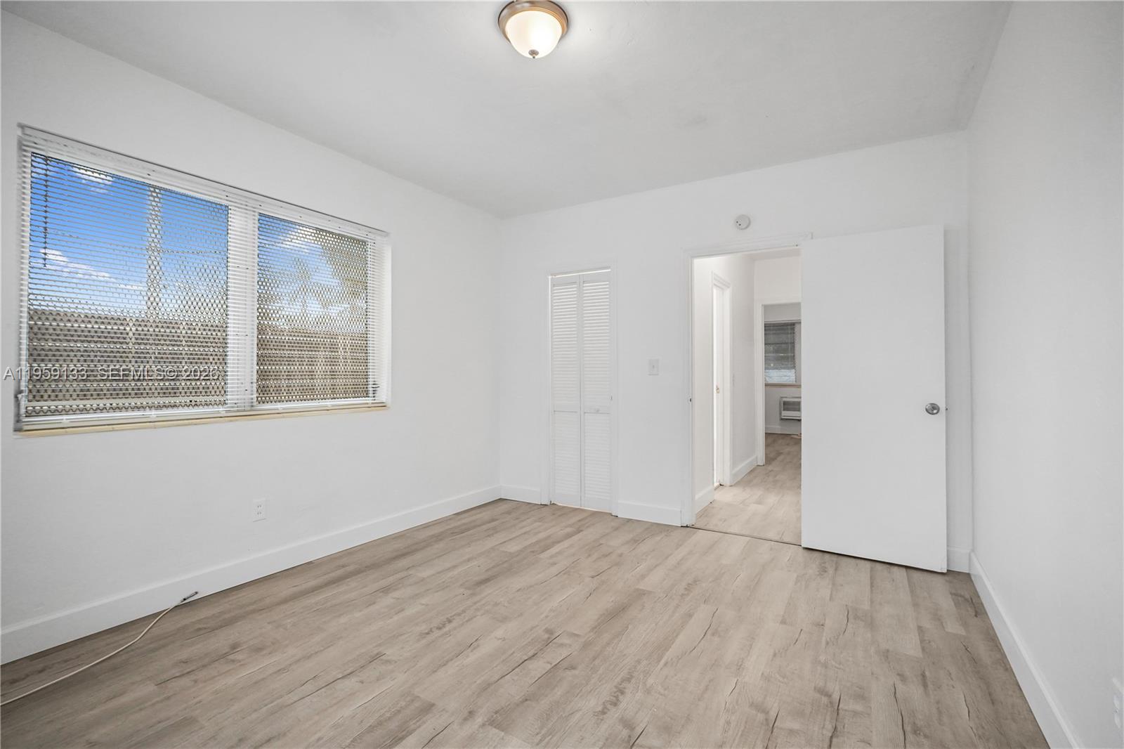 710 82nd Street, Unit 4 Miami Beach, FL 33141 - Photo 19 of 33 a view of empty room with wooden floor and fan