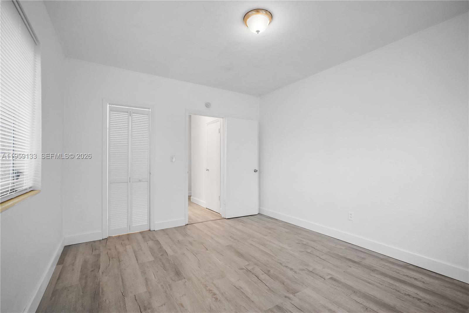 710 82nd Street, Unit 4 Miami Beach, FL 33141 - Photo 20 of 33 an empty room with wooden floor
