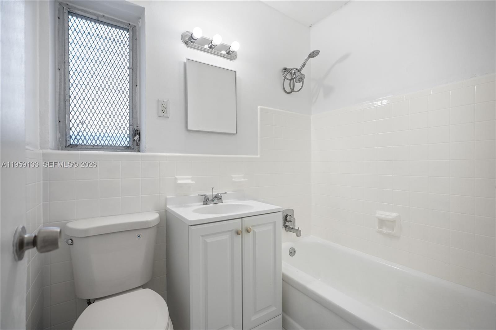 710 82nd Street, Unit 4 Miami Beach, FL 33141 - Photo 23 of 33 a bathroom with a sink a toilet and shower