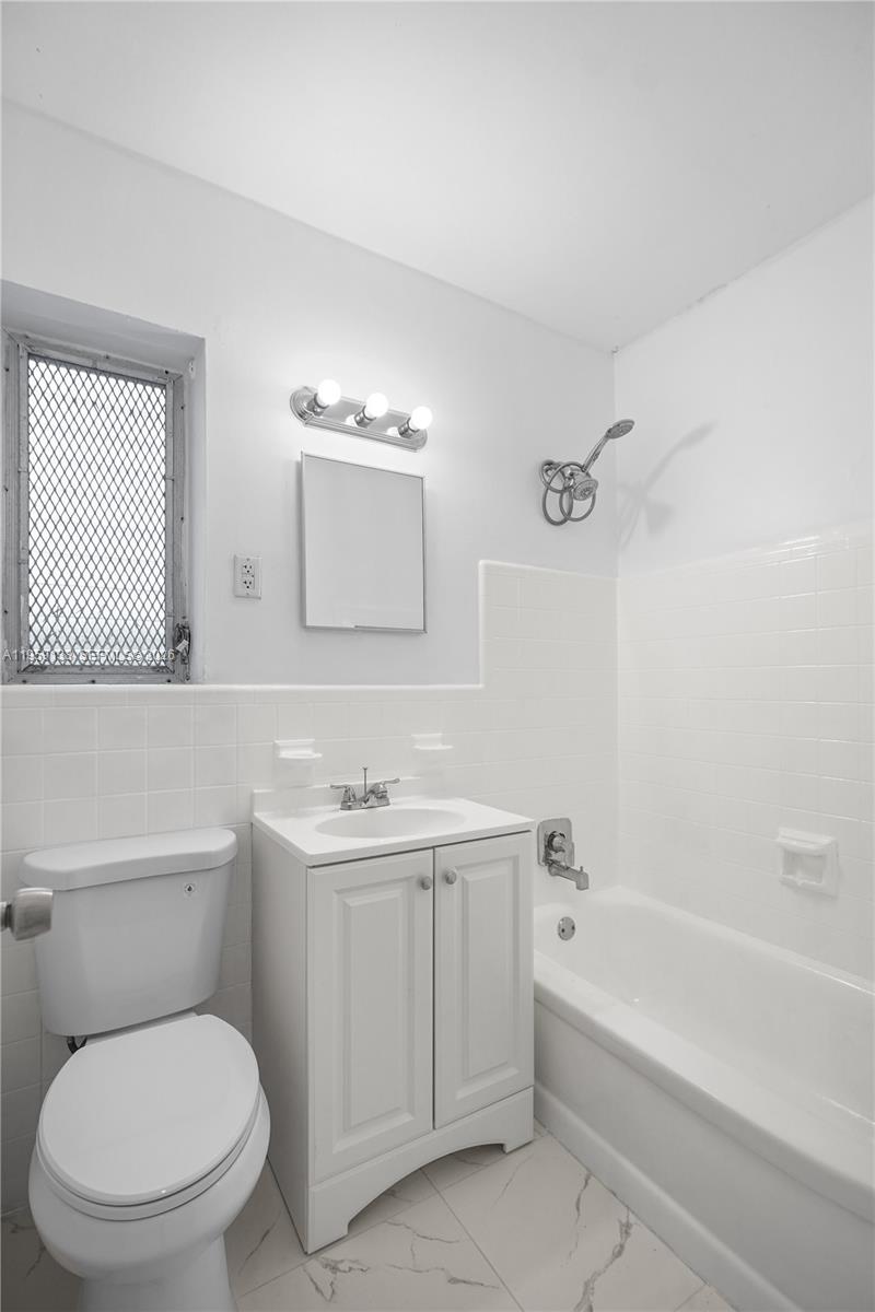 710 82nd Street, Unit 4 Miami Beach, FL 33141 - Photo 24 of 33 a bathroom with a toilet a sink and a bathtub