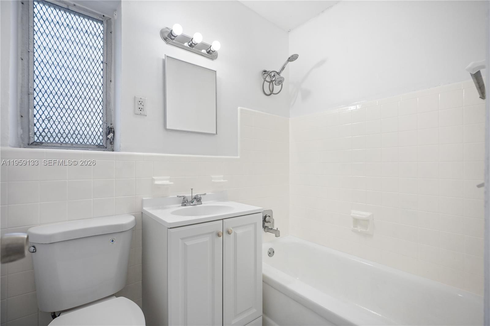 710 82nd Street, Unit 4 Miami Beach, FL 33141 - Photo 25 of 33 a bathroom with a sink toilet vanity and bathtub